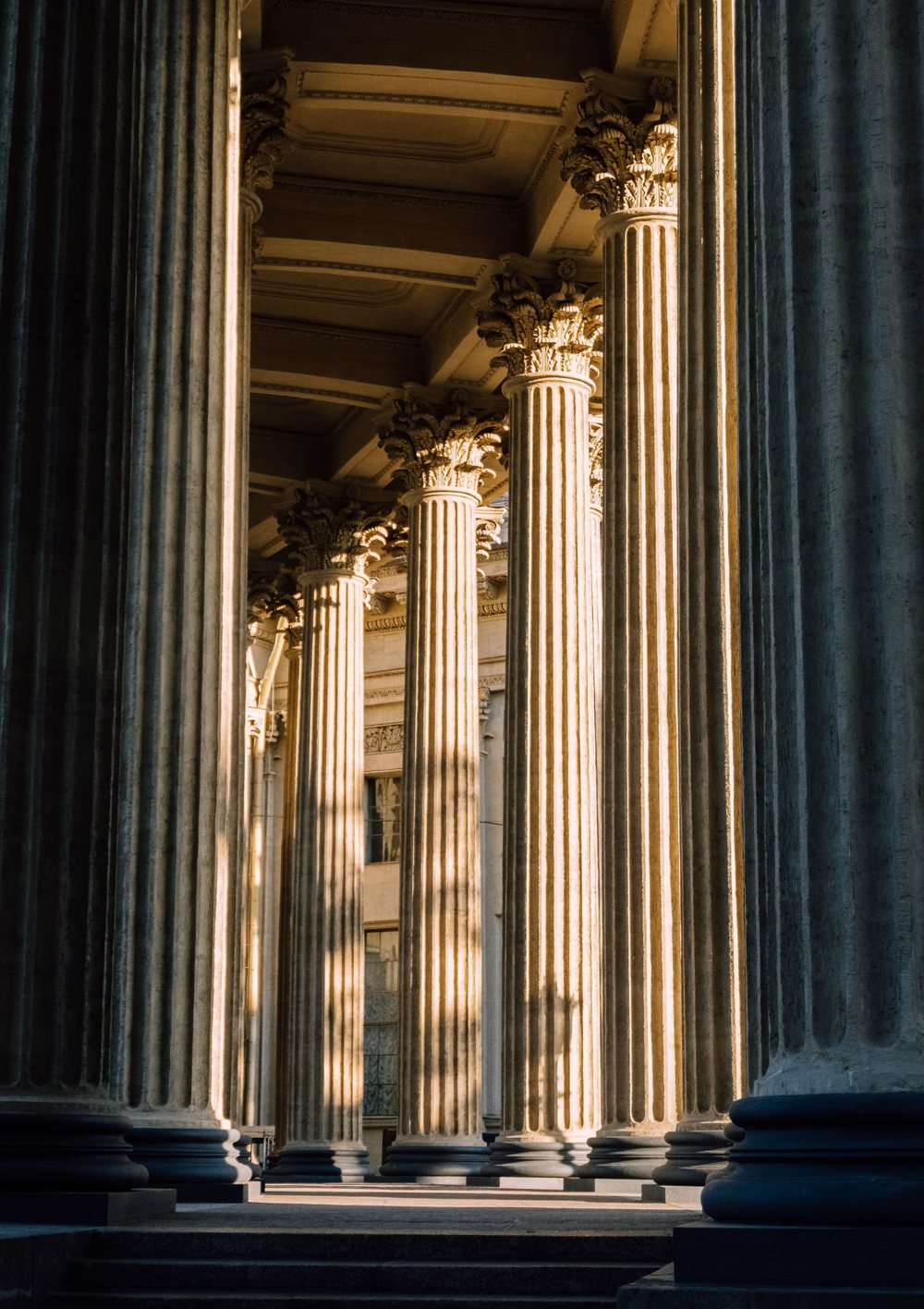 Row of fluted Corinthian columns in late afternoon light